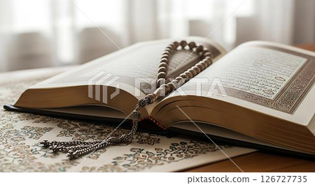 Quran and prayer beads on prayer mat Quran and prayer beads on prayer mat 126727735