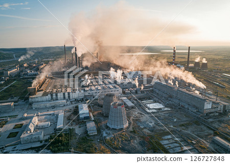 Air pollution from industrial facilities causes environmental concerns in urban areas during sunset hours. Air pollution from industrial facilities causes environmental concerns in urban areas during sunset hours. 126727848