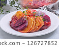 Sweet potato, parsnips and beet root gratin with thyme and melted cheese, on white plate, horizontal 126727852