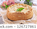 Freshly baked old fashioned deep dish peach pie cooling on baking rack, horizontal 126727861