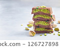 Stack of chocolate bars with pistachio and kadaifi filing, horizontal copy space 126727898