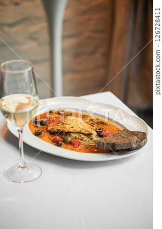 Portion of dorado fish with puttanesca sauce Portion of dorado fish with puttanesca sauce 126728411