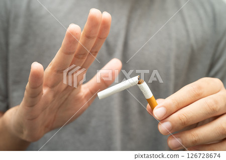 Quit smoking, Asian teenage man breaking destroy cigarette in hand. Quit smoking, Asian teenage man breaking destroy cigarette in hand. 126728674