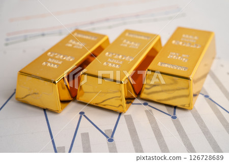 Gold bars on graph paper, finance trading investment business currency. 126728689