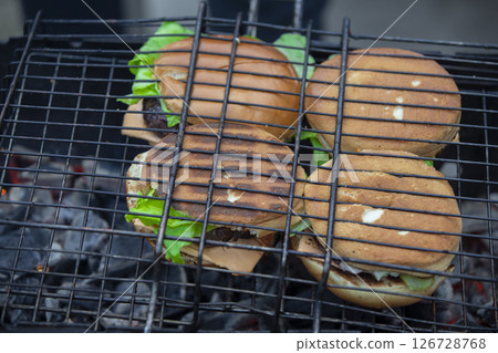 Cooking hamburgers on the wire rack. Street food. 126728768