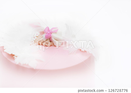 Pink baptism cake with a little baby figurine. Background baptism of a girl. 126728776