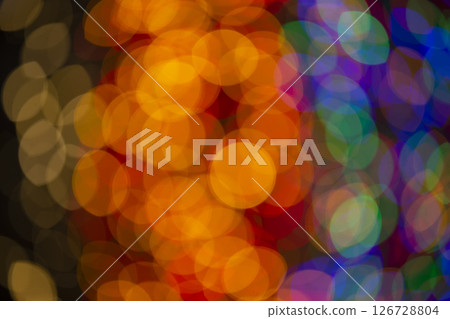 Multi-colored large bokeh spots of blue, yellow and orange. Bokeh from a Christmas garland. 126728804