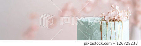 This enchanting sage green cake features delicate pressed edible flowers and shimmering gold leaf veins, beautifully showcasing an eco-friendly and natural aesthetic. Perfect for celebrations 126729238