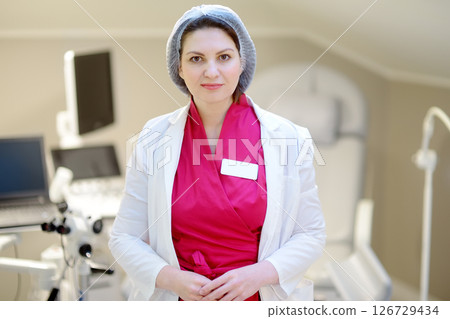 Portrait of female obstetrician gynecologist in office during appointment of patient. 126729434