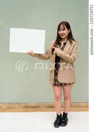 Asian young woman holding a blank board copyspace 126729751