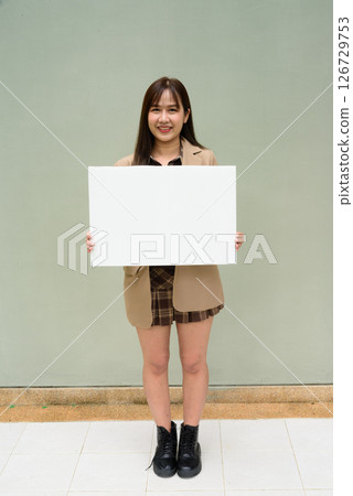 Asian young woman holding a blank board copyspace 126729753