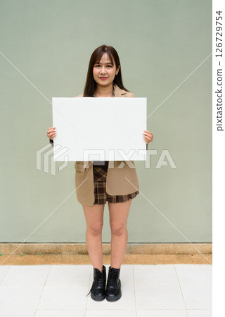 Asian young woman holding a blank board copyspace 126729754
