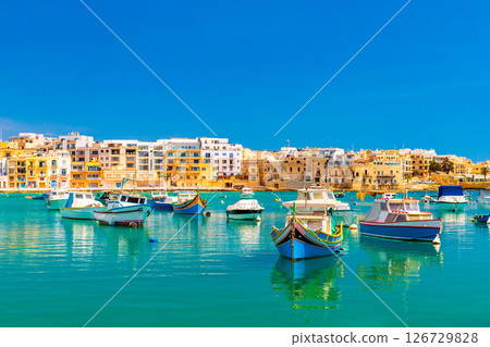 A view of numerous fishing boats in St George's Bay in Birzebbuga, a small coastal town in Malta 126729828