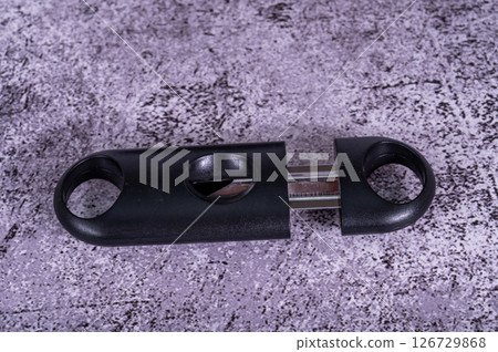A black cigar cutter isolated placed on the table 126729868