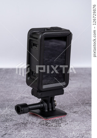 black action camera front view placed on the table 126729876