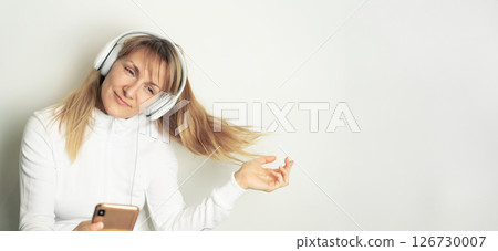 Woman enjoying music with headphones Woman enjoying music with headphones 126730007