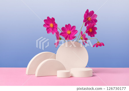 White round podium set on a gradient blue background with purple cosmos flowers. Concept scene stage showcase for new product, sale, cosmetic, presentation. Abstract geometric composition in 126730177