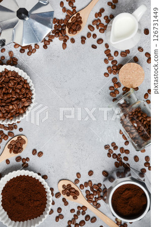 Coffee beans, ground coffee, and brewing tools arranged on a textured surface, creating an inviting atmosphere for coffee lovers and enthusiasts 126731449