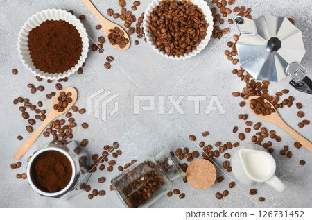 Coffee beans, ground coffee, and brewing tools arranged on a textured surface, creating an inviting atmosphere for coffee lovers and enthusiasts Coffee beans, ground coffee, and brewing tools arranged on a textured surface, creating an inviting atmosphere for coffee lovers and enthusiasts 126731452