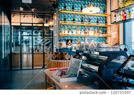 Modern coffee shop interior featuring a sleek barista counter and stylish decor in a vibrant urban setting 126731597