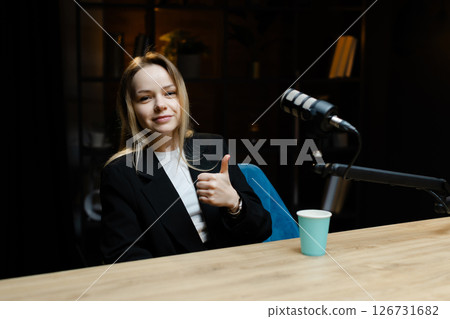Smiling woman recording podcast in home studio Smiling woman recording podcast in home studio 126731682