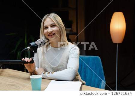Smiling woman recording podcast in home studio Smiling woman recording podcast in home studio 126731684