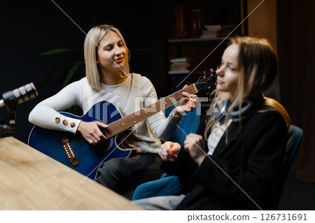 Musicians composing a song playing acoustic guitar and keeping time 126731691