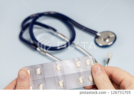 Female hands holding pills in blister. Prescription medication Female hands holding pills in blister. Prescription medication 126731705