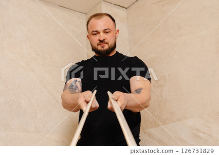 Construction worker installing ceramic tiles on bathroom wall using level tool 126731829