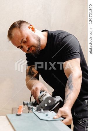 Construction Worker Using Tile Saw Cutting Ceramic Tiles Construction Worker Using Tile Saw Cutting Ceramic Tiles 126731840