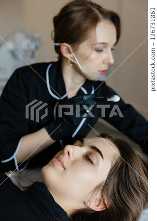 Professional Beautician Applying Lip Makeup Gently 126731861