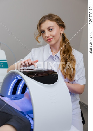 Beautician using modern equipment for facial skin treatment Beautician using modern equipment for facial skin treatment 126731904