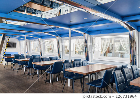 A Modern Restaurant Interior Featuring Stylish Blue Decor Alongside Beautiful Scenic Views 126731964