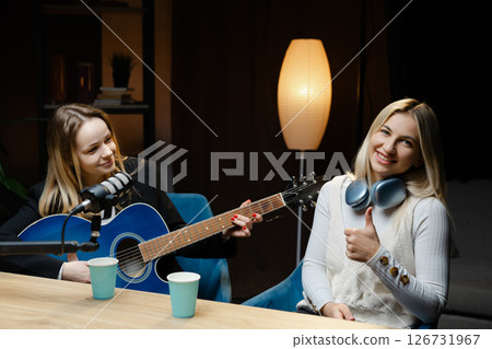 Musicians playing acoustic guitar and recording music in home studio 126731967