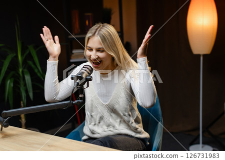 Radio host speaking with energy during a live podcast recording Radio host speaking with energy during a live podcast recording 126731983