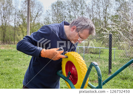 Installing flat free wheel on utility cart to improve durability and reduce maintenance by eliminating risk of tire flats during use. 126732450