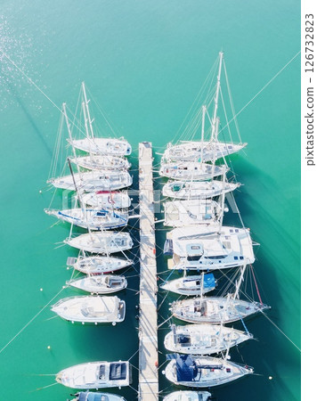 Sailboats at the pier in Rethymno against the backdrop of unreal turquoise sea 126732823