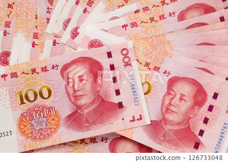 Big pile of different Chinese yuan banknotes 100 . Chinese paper currency Yuan renminbi banknotes and coins. Copy space. Close up. 126733048