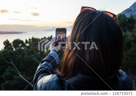 Tourist taking a selfie at sunset. Summer tourism with friends. Lifestyle 126733071