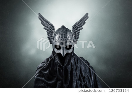 Warrior spirit with winged helmet over dark misty background Warrior spirit with winged helmet over dark misty background 126733134