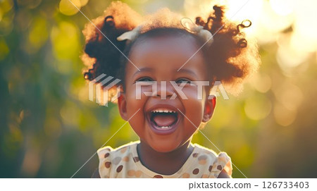 A little girl is joyfully laughing and making eye contact with the camera A little girl is joyfully laughing and making eye contact with the camera 126733403