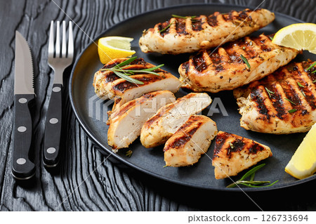 grilled chicken breast with lemon on a plate grilled chicken breast with lemon on a plate 126733694