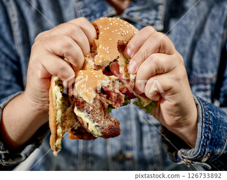 broken burger in human hands 126733892