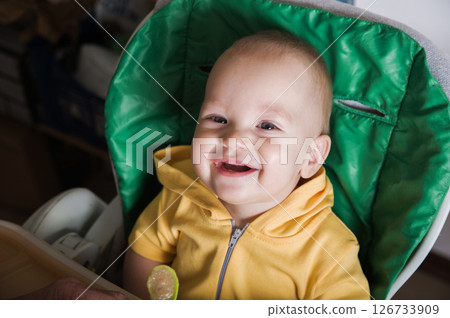 Happy Baby Being Fed by Grandmother at Home Happy Baby Being Fed by Grandmother at Home 126733909