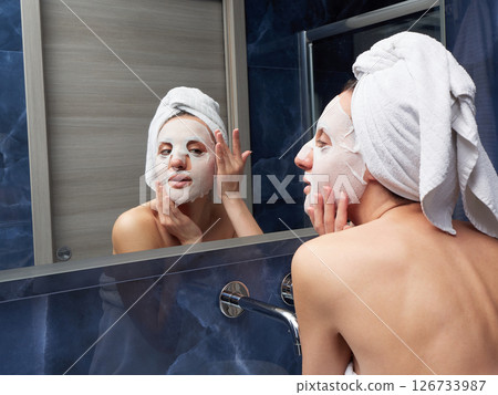 Woman put face mask at bathroom Woman put face mask at bathroom 126733987