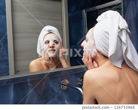 Woman put face mask at bathroom Woman put face mask at bathroom 126733988