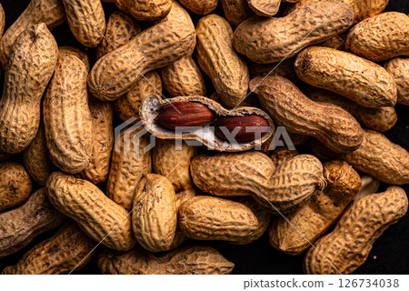 Pile of peanuts with one opened pod 126734038