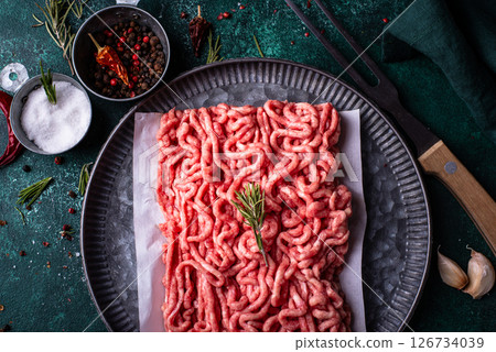 Raw minced meat on dark background Raw minced meat on dark background 126734039