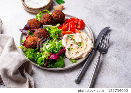 Salad with hummus, falafel and vegetables Salad with hummus, falafel and vegetables 126734090