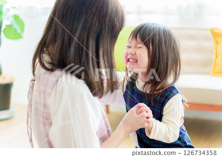 Nursery teacher playing with girls 126734358